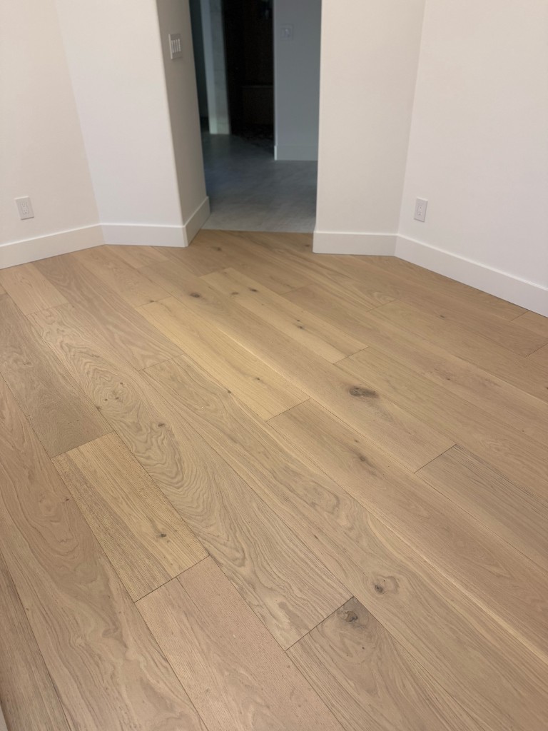 Hardwood floor installation in a Tri-Cities home—planks laid in progress by Kraft Floors & Interiors