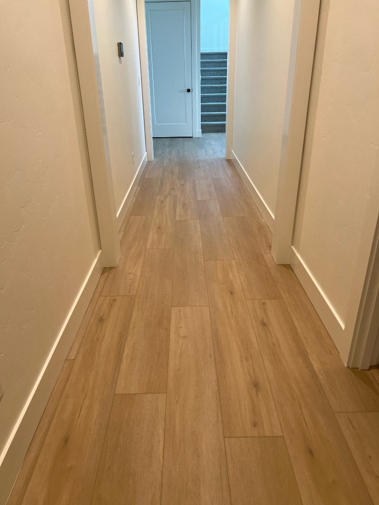 Modern hallway with light oak wood-look plank flooring