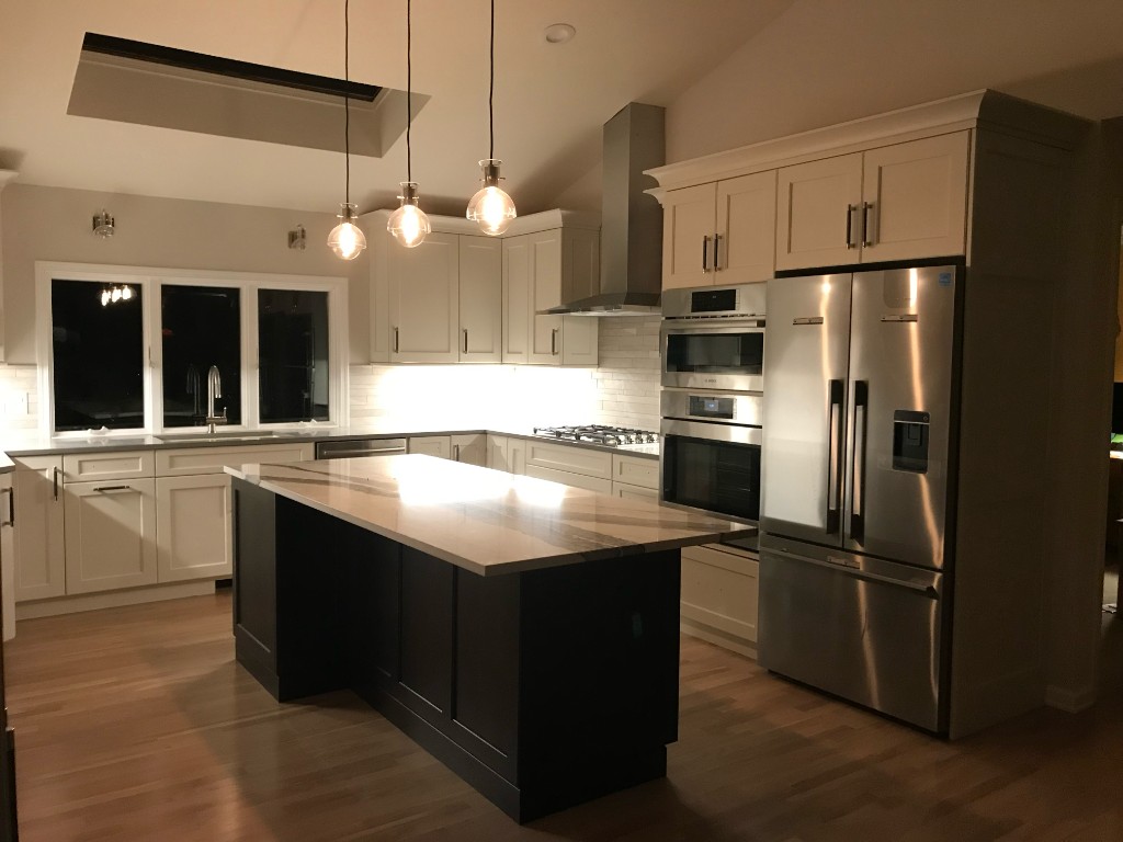 Kitchen remodel with marble island and shaker cabinetry